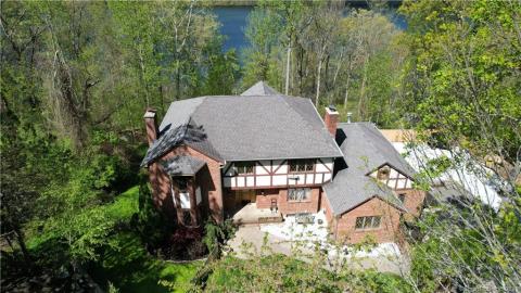 Rear of house. Windows and balconies look out onto the lake.