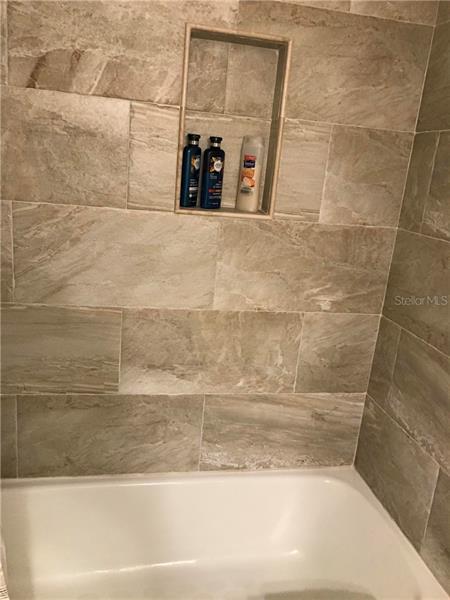 2nd bathroom with beautiful tub and tile