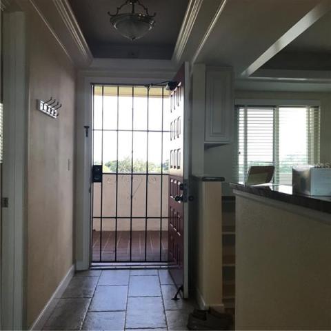 Entry with beautiful tile, tray ceiling with lovely light.