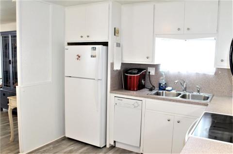 Kitchen with mini dishwasher, fridge, range and microwave. Kitchen with mini dishwasher, fridge, range and microwave.