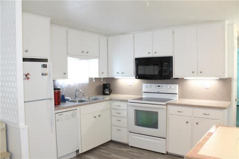 Kitchen with mini dishwasher, fridge, range and microwave. Kitchen with mini dishwasher, fridge, range and microwave.