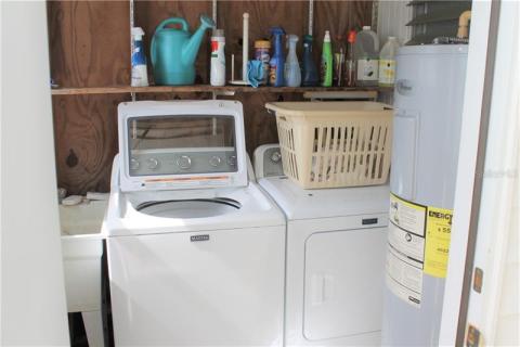Full size washer and dryer along with utility sink. Full size washer and dryer along with utility sink.