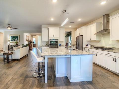 Chef's kitchen island with granite countertop and beautiful panels