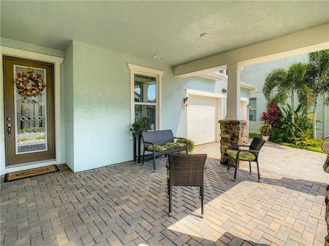 Ample driveway and entryway with sealed pavers.