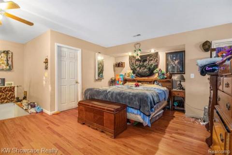 Bedroom with light wood finished floors and a ceiling fan