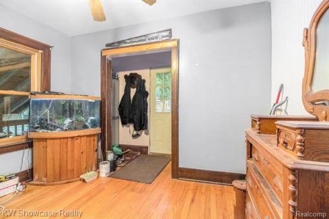 Entrance foyer with light wood-style floors and a ceiling fan