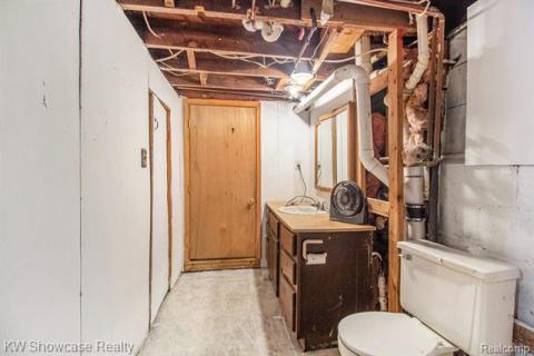 Paetially finihed belowgrade area with a sink