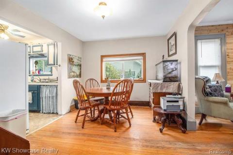 Dining space with light wood-style floors, healthy amount of natural light, and a ceiling fan