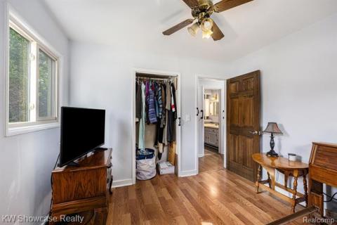 Bedroom featuring wood finished floors, a closet, and ceiling fan