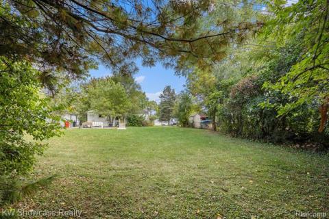 View of green lawn with a patio