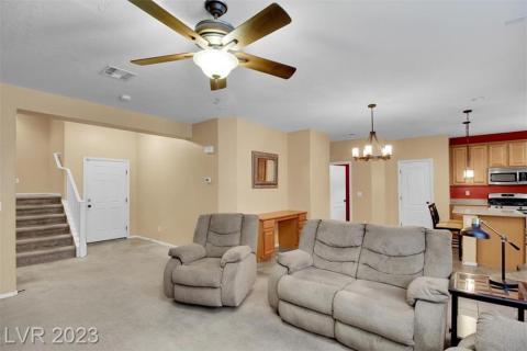 Spacious living area with ceiling fans.