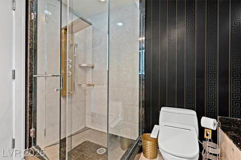 Full bathroom featuring a stall shower and toilet Full bathroom featuring a stall shower and toilet