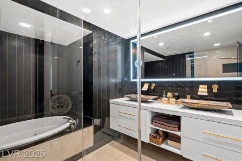 Bathroom with vanity, tasteful backsplash, recessed lighting, a whirlpool tub, and tile patterned floors Bathroom with vanity, tasteful backsplash, recessed lighting, a whirlpool tub, and tile patterned floors