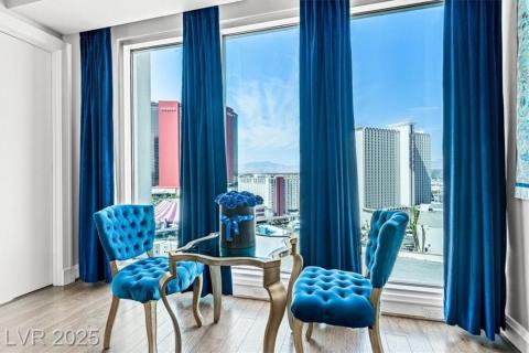 Living area featuring wood finished floors and a city view Living area featuring wood finished floors and a city view