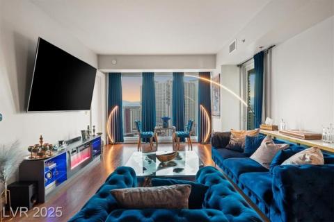 Living area with a wealth of natural light, visible vents, and wood finished floors Living area with a wealth of natural light, visible vents, and wood finished floors