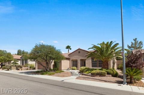 Mediterranean / spanish home with an attached garage, stucco siding, driveway, and a tile roof