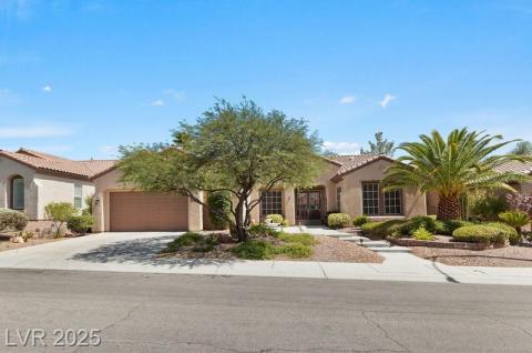 Mediterranean / spanish house featuring stucco siding, driveway, a tile roof, and a garage