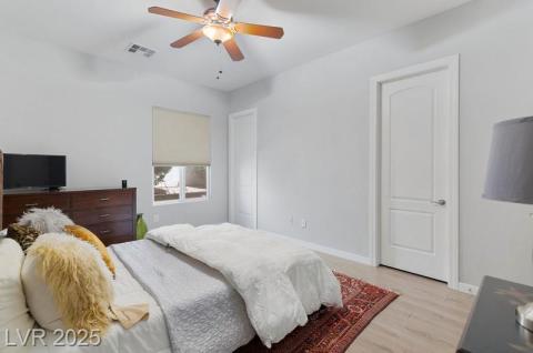 Bedroom featuring light wood-type flooring and ceiling fan