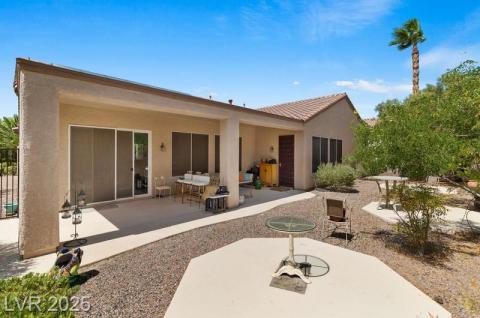Back of house with a patio area, stucco siding, and a tile roof