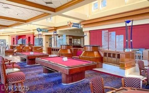 Game room with pool table, beamed ceiling, coffered ceiling, and plenty of natural light