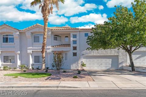 Mediterranean / spanish-style house featuring a balcony, stucco siding, concrete driveway, a tile roof, and a garage