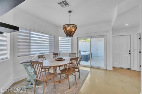 Dining space with concrete floors and a chandelier