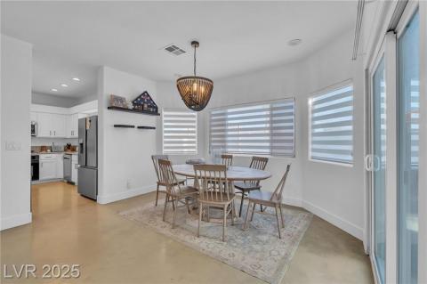 Dining room featuring finished concrete floors, a chandelier, and recessed lighting
