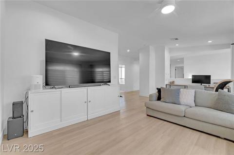 Upstairs Living area featuring light wood finished floors, recessed lighting, and ceiling fan. This space is large enough to convert to a 3rd bedroom and still have room for a loft.