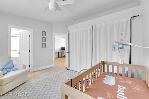 Bedroom w/mountain views featuring a nursery area and ceiling fan