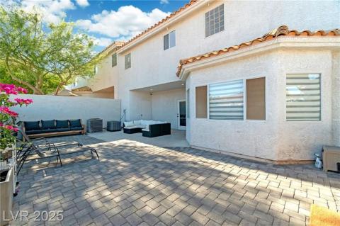 Rear view of house with a patio, an outdoor living space, a tile roof, and stucco siding
