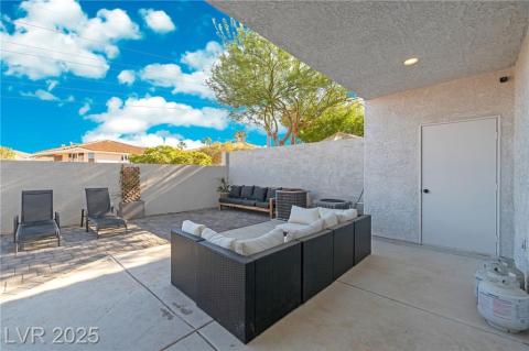 Fenced backyard with a patio and an outdoor hangout area