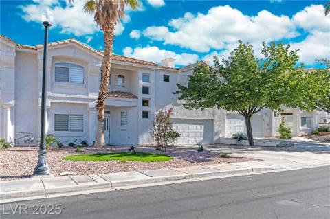 Mediterranean / spanish house with driveway, stucco siding, a tile roof, and a balcony