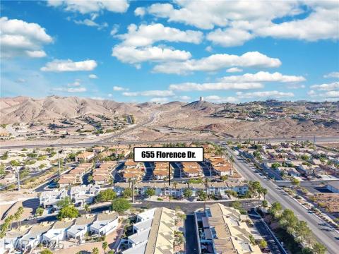 View of property location featuring nearby suburban area and a mountain backdrop