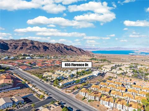 Aerial perspective of suburban area featuring a water and mountain view