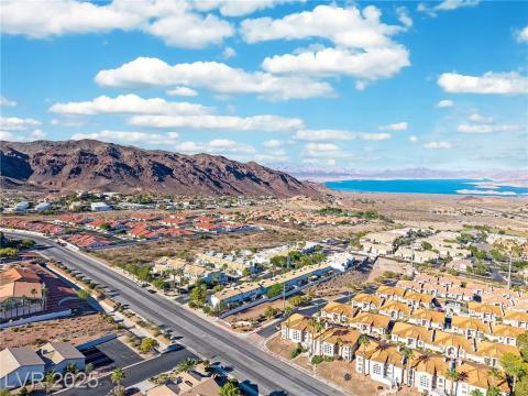 Aerial perspective of suburban area with a water and mountain view