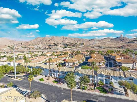 Aerial perspective of suburban area featuring a mountain backdrop