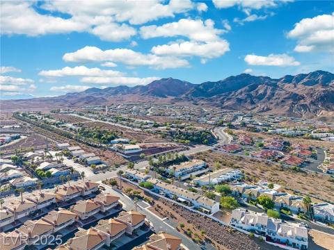 Aerial perspective of suburban area featuring a mountain backdrop