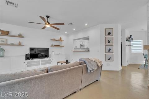 Living room featuring concrete floors, recessed lighting, and ceiling fan