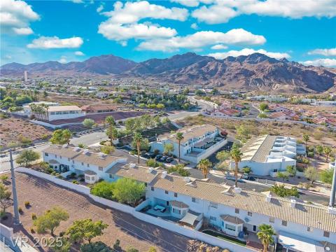 Aerial view of residential area featuring a mountainous background