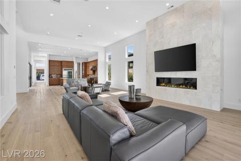 Family room featuring a marble fireplace, luxury wood plank flooring, recessed lighting, 6ft linear remote controlled fireplace Family room featuring a marble fireplace, luxury wood plank flooring, recessed lighting, 6ft linear remote controlled fireplace