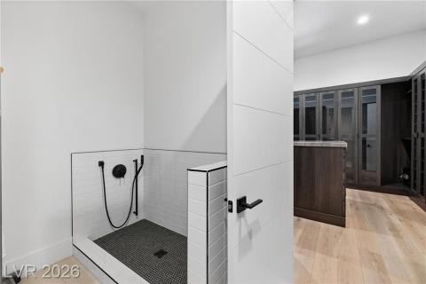 Laundry Room featuring a pet bath & private entry to primary closet Laundry Room featuring a pet bath & private entry to primary closet