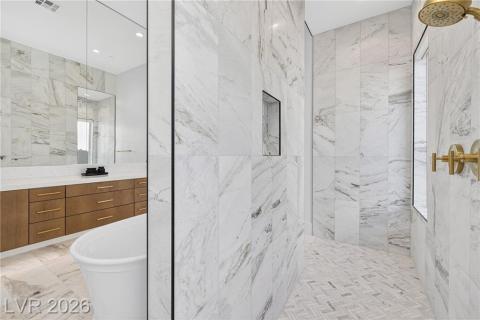 Primary resort spa-like bath with a marble finished shower, a freestanding tub, light marble finish floors Primary resort spa-like bath with a marble finished shower, a freestanding tub, light marble finish floors