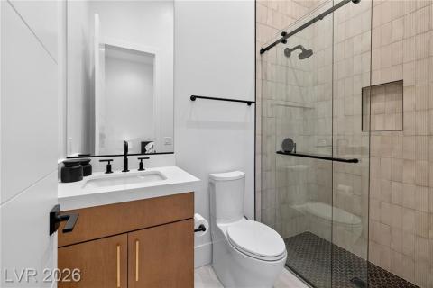 Bathroom with vanity and a shower with barn styled glass doors. Bathroom with vanity and a shower with barn styled glass doors.