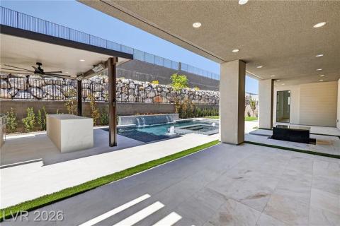 Pergola with ceiling fan, a patio area from family room, and a pool with spa and water features Pergola with ceiling fan, a patio area from family room, and a pool with spa and water features
