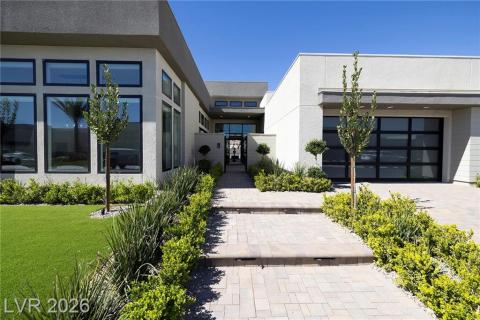 Modern home featuring driveway, a front lawn, added/upgraded steps to front gate and an attached garage Modern home featuring driveway, a front lawn, added/upgraded steps to front gate and an attached garage