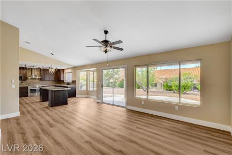 This bright interior features water proof plank flooring, a functional kitchen island, and expansive windows with sliding doors. This bright interior features water proof plank flooring, a functional kitchen island, and expansive windows with sliding doors.