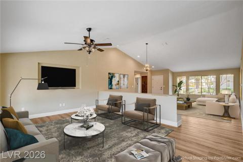 Step into a spacious living area featuring soaring vaulted ceilings and natural light from large windows. Step into a spacious living area featuring soaring vaulted ceilings and natural light from large windows.