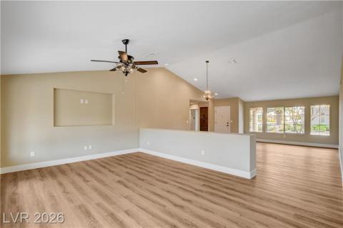 This airy living area features high ceilings and wood flooring, creating an inviting atmosphere for daily living. This airy living area features high ceilings and wood flooring, creating an inviting atmosphere for daily living.