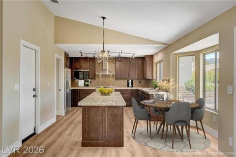 Culinary delights await in this modern kitchen with granite counters and rich wood cabinetry. Culinary delights await in this modern kitchen with granite counters and rich wood cabinetry.