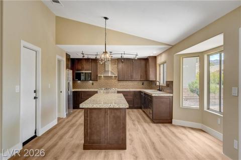 This spacious kitchen offers a large island, generous counter space, and durable flooring. This spacious kitchen offers a large island, generous counter space, and durable flooring.
